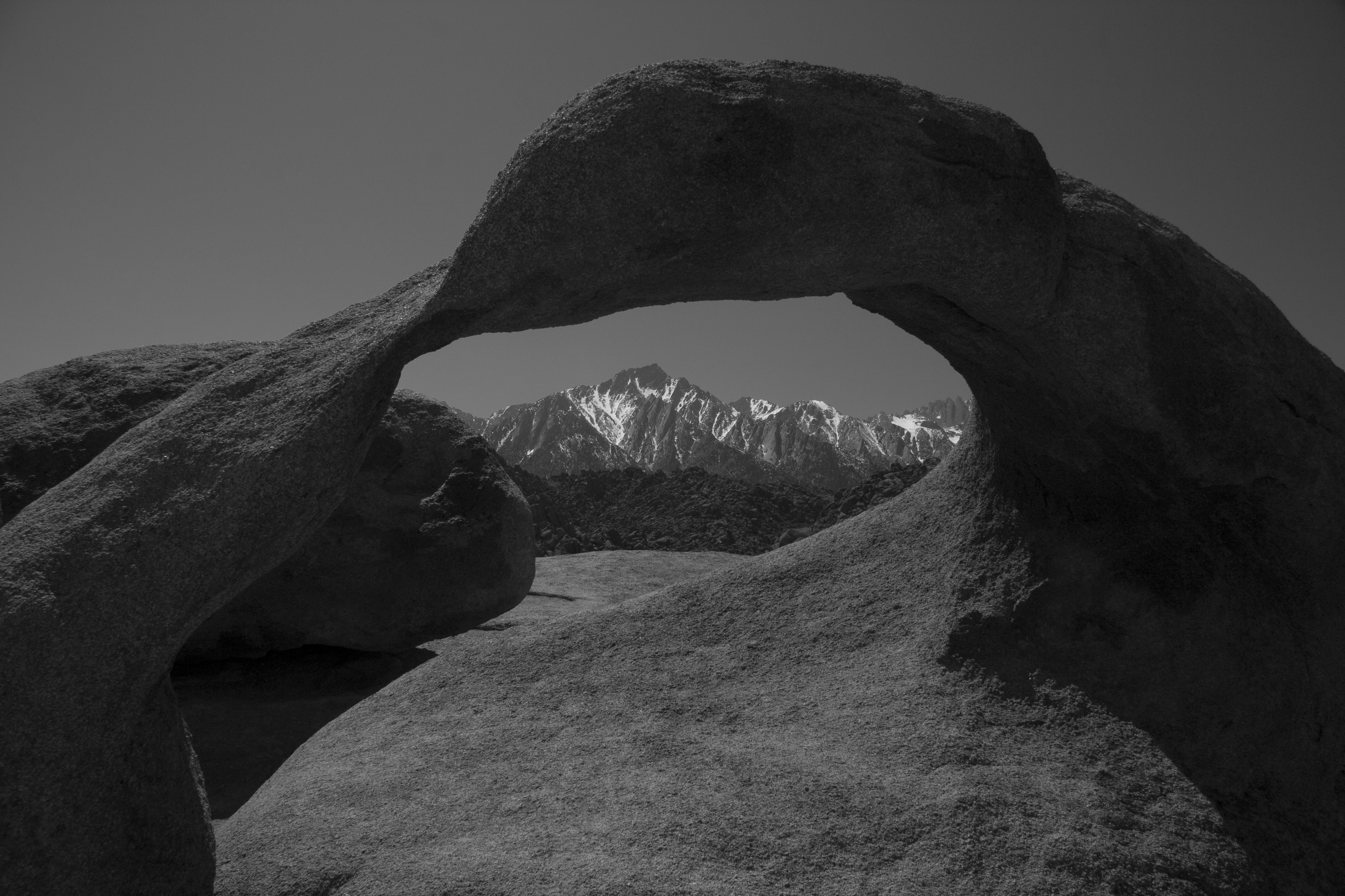Natural arch framing the Sierra peaks at Whitney Portal